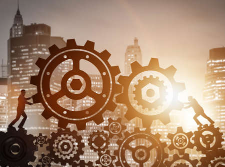 Businessman in teamwork concept with cogwheelsの写真素材