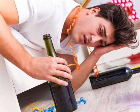 Man after heavy christmas partying at homeの写真素材