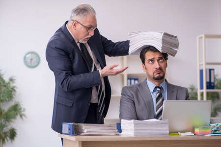 Two male employees in bullying conceptの写真素材