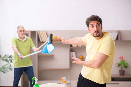 Two male contractors cleaning the houseの写真素材
