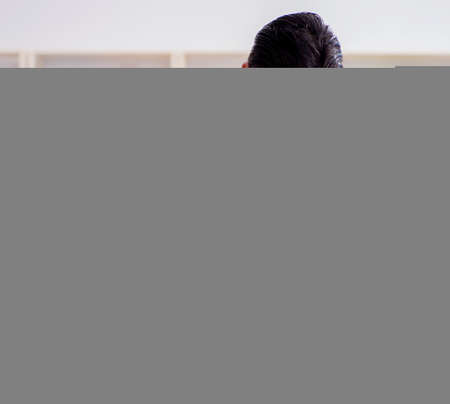 Young male cook working in the kitchenの写真素材