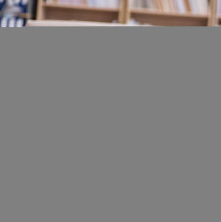 Young handsome man playing with white kittenの写真素材