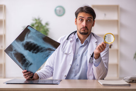 Young male doctor radiologist working in the clinicの写真素材