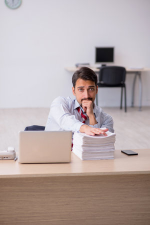 Young male employee sitting at workplaceの写真素材