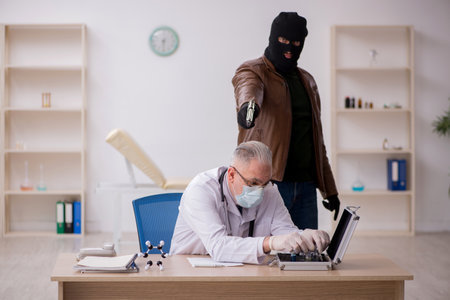 Masked man burglar stealing vaccine from old doctor
