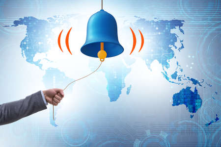 Businessman ringing the bell in case of dangerの写真素材