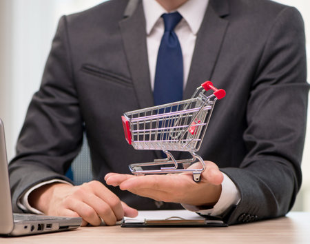 Businesswoman with shopping cart trolleyの写真素材