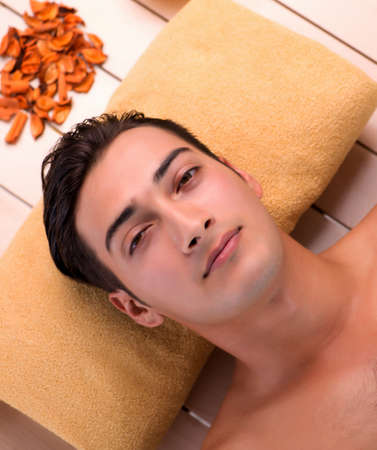 Young handsome man during spa procedureの写真素材