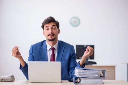 Young male employee working in the officeの写真素材