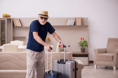 Old man preparing for trip at homeの写真素材