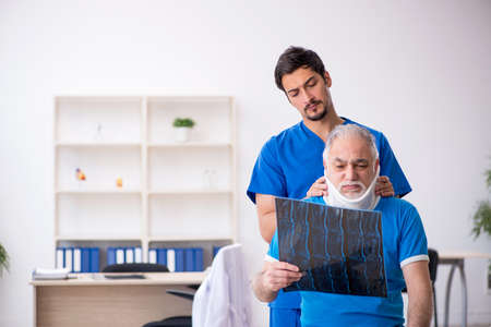 Old male patient visiting young male doctor radiologistの写真素材