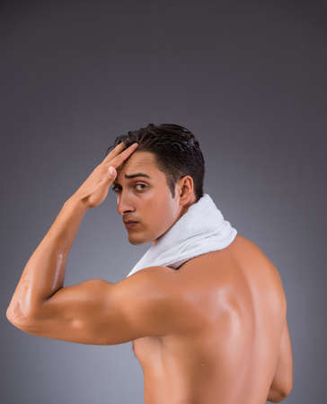 Man after taking shower on dark backgroundの写真素材