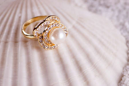 Golden ring and sea shellの写真素材