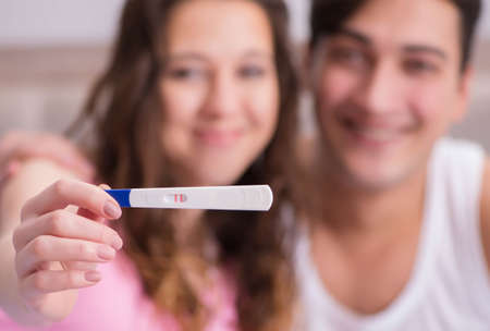 Happy couple finding out about pregnancy test resultsの写真素材
