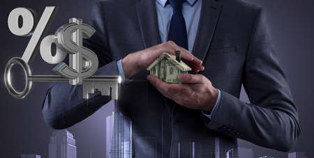 Young handsome businessman in mortgage concept