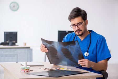 Young male doctor radiologist working in the clinicの写真素材