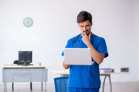 Young male doctor working in the clinicの写真素材