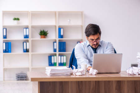 Young male employee rejecting new ideas in the officeの写真素材