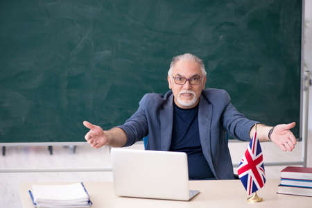 Old male english language teacher in the classroomの写真素材