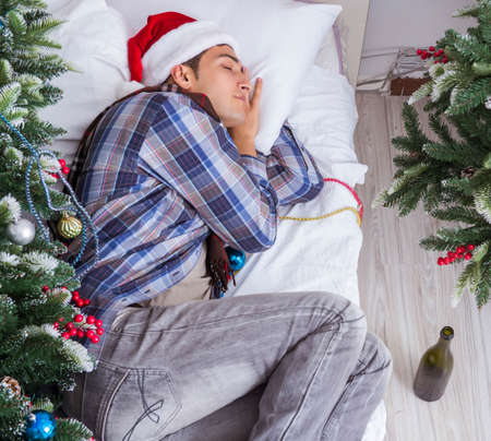 Man suffering hangover after christmas partyの写真素材
