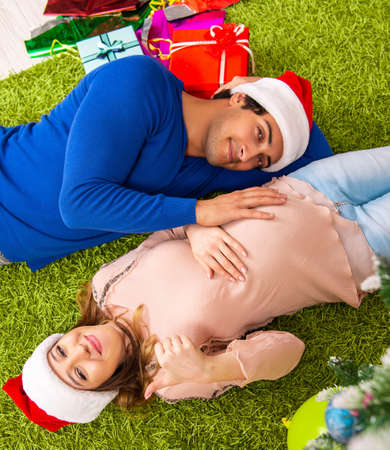 Pregnant wife celevrating christmas with husband