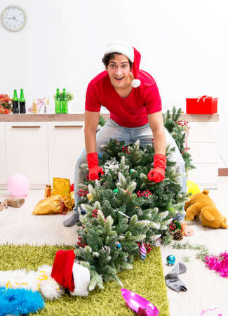 Young man drunk at home after christmas partyの写真素材