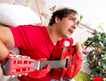 Young man drunk at home after christmas partyの写真素材