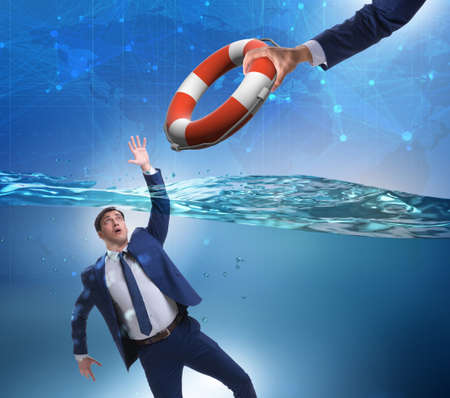 Businessman being saved from drowningの写真素材