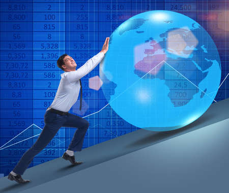 Businessman pushing earth in business conceptの写真素材
