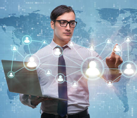 Businessman with laptop in social network conceptの写真素材