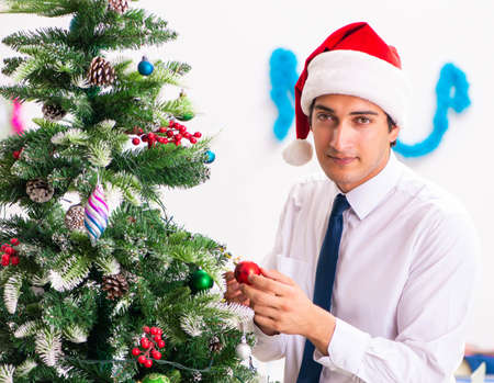 Employee businessman celebrating christmas in officeの写真素材