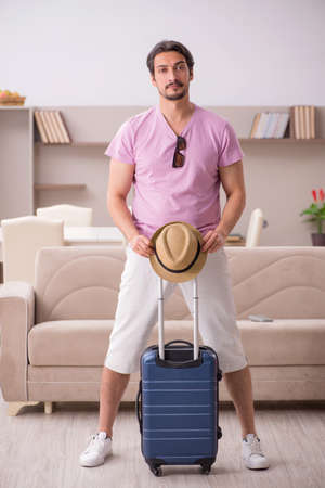 Young man preparing for trip at homeの写真素材