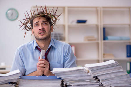 Young male employee wearing prickly wreath on headの写真素材