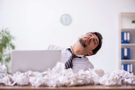 Young male employee in brainstorming conceptの写真素材