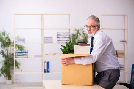 Old male employee in dismissal conceptの写真素材