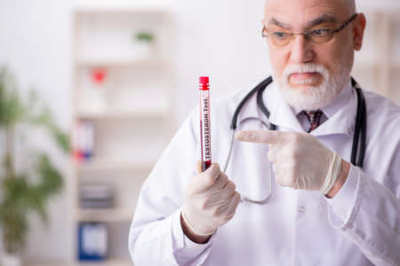 Old male doctor hematologist working in the clinicの写真素材