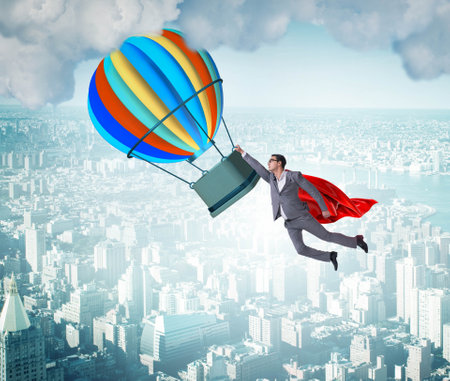 Businessman flying on balloon in challenge conceptの写真素材