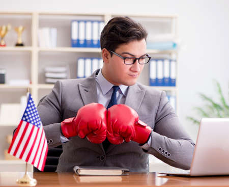 Businessman with American flag in officeの写真素材