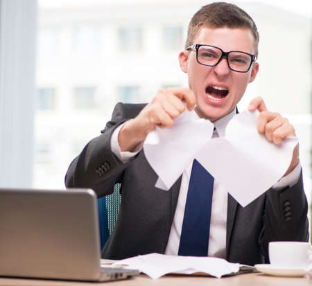 Businessman working with much paperworkの写真素材