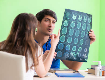 Female patient visiting male doctor in medical concept