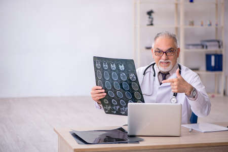 Old male doctor radiologist working at the hospitalの写真素材