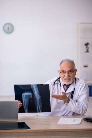 Old male doctor radiologist working at the hospitalの写真素材