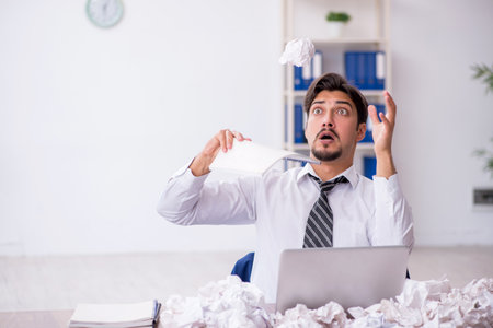 Young male employee in brainstorming conceptの写真素材