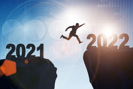Man jumping from year 2021 to 2022