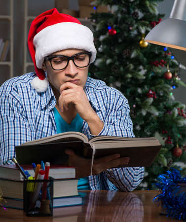 Young man working at home on christmas dayの写真素材