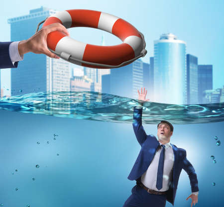 Businessman being saved from drowningの写真素材