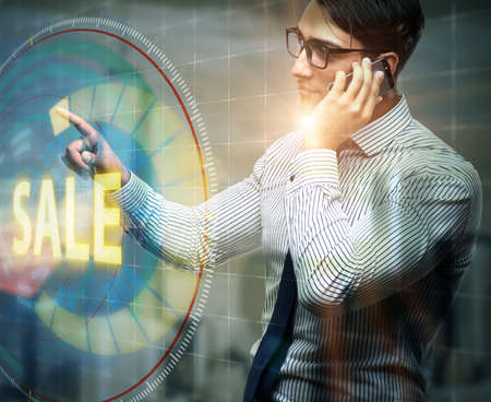 Businessman pressing buttons in sale conceptの写真素材
