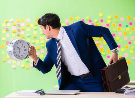 Businessman with many conflicting priorities in time managementの写真素材