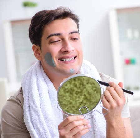 Handsome applying clay mask on faceの写真素材