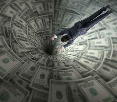 Businessman fighting against dollar funnelの写真素材